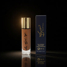 Load image into Gallery viewer, A bottle of V3NOM Vegan Foundation next to its packaging box. The foundation bottle is clear with a gold cap, and the box is black with gold text.